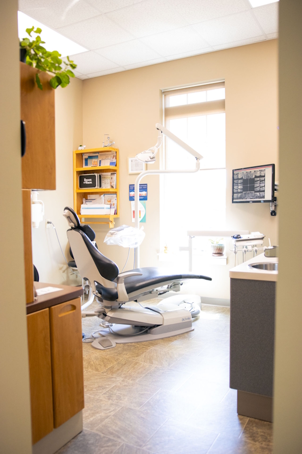 photo of a dentist office dental chair surrounded by dental equipment
